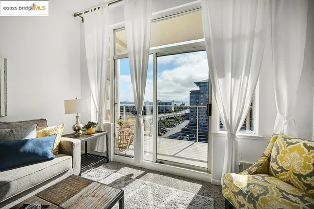 a living room with furniture and a floor to ceiling window