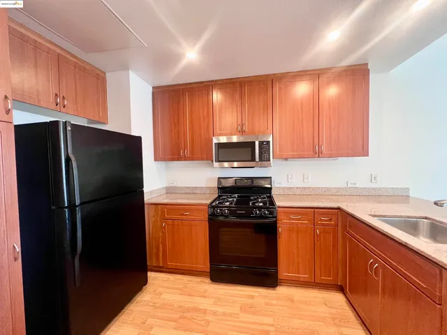 a kitchen with stainless steel appliances a refrigerator and a sink