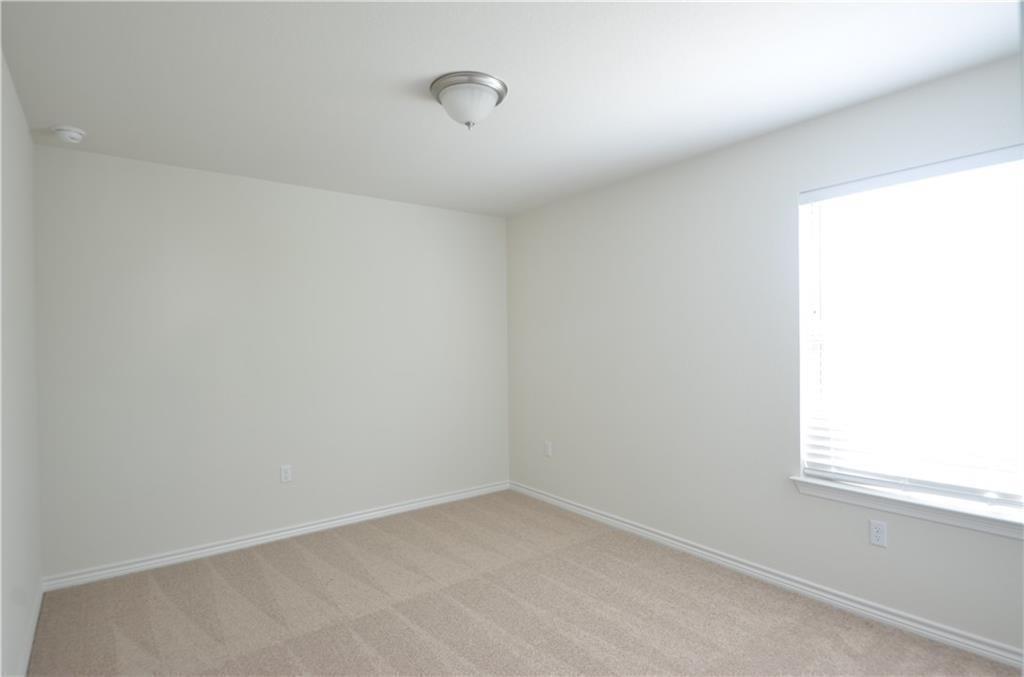 14403 McCoy Loop Austin, TX 78717 - Photo 25 of 29 A spacious room offers comfortable carpeting, ready for personalization.