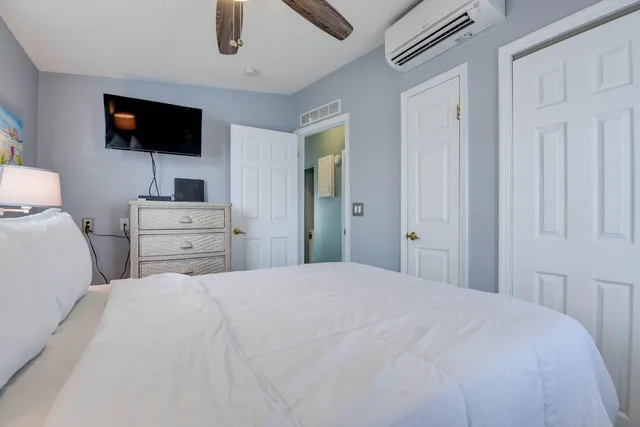 a bedroom with a bed and a flat screen tv