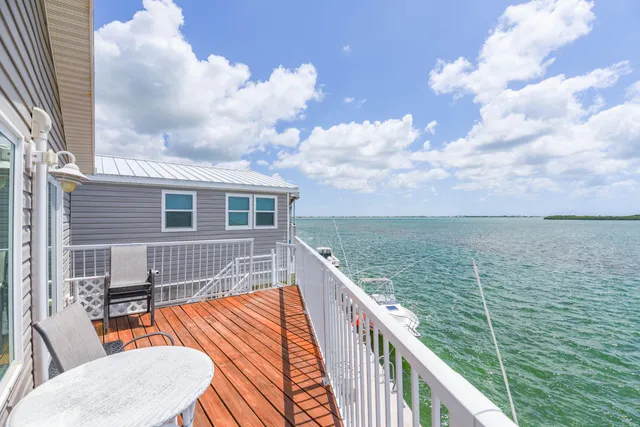 a balcony with table and chairs