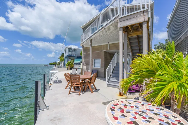 a view of a patio with table and chairs and potted plants