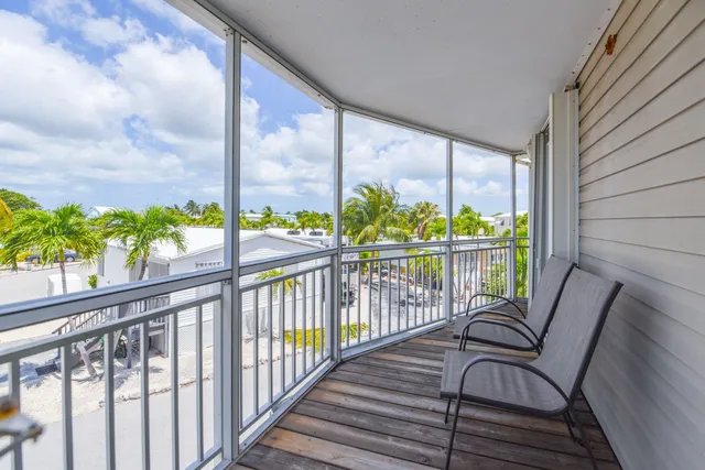 a view of a chair and table in the balcony