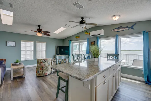 a kitchen with a table chairs and wooden floor