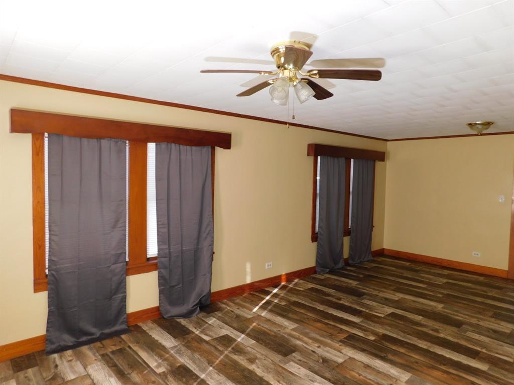 405 8th Street Northwest Springhill, LA 71075 - Photo 12 of 25 a bedroom with a bed and a chandelier