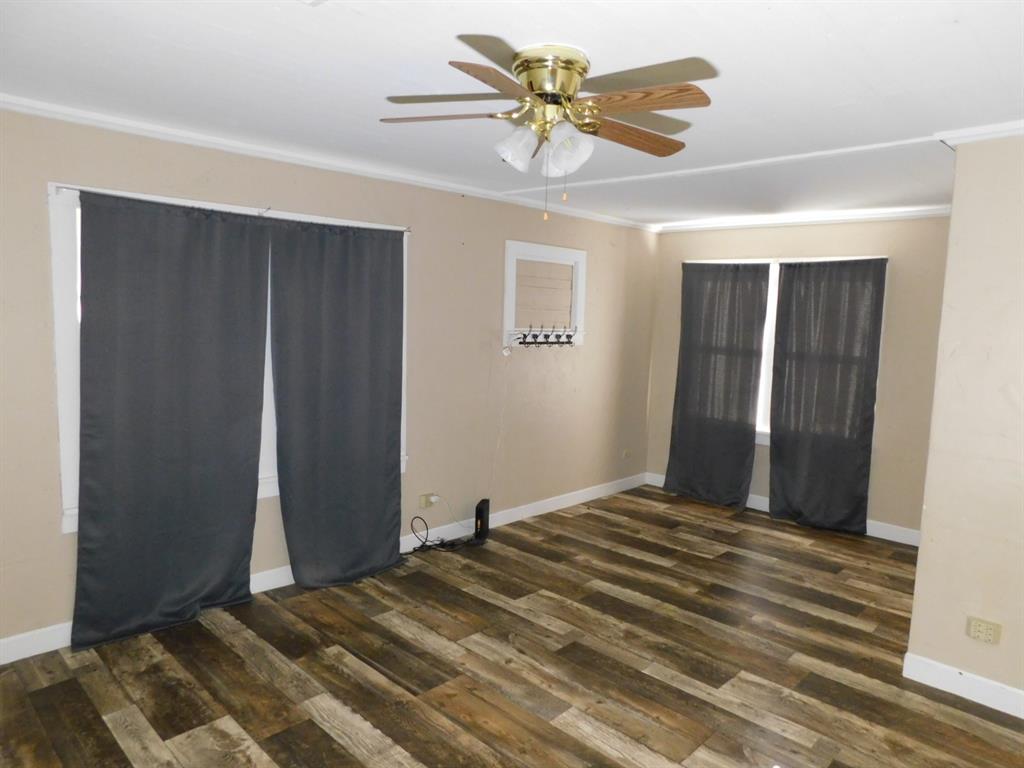 405 8th Street Northwest Springhill, LA 71075 - Photo 17 of 25 a bedroom with a bed and a chandelier fan