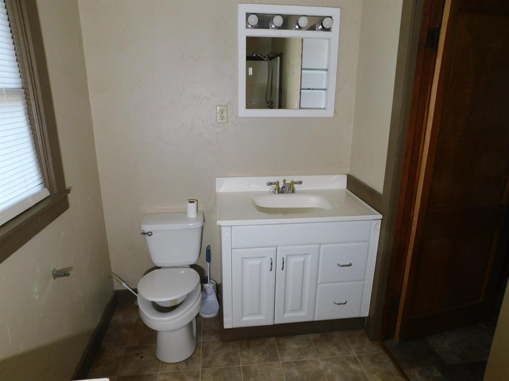 405 8th Street Northwest Springhill, LA 71075 - Photo 23 of 25 a bathroom with a toilet sink and mirror