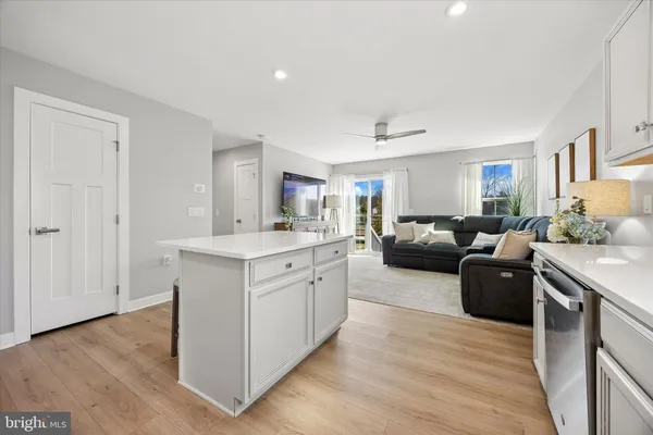 a living room with furniture and a dresser