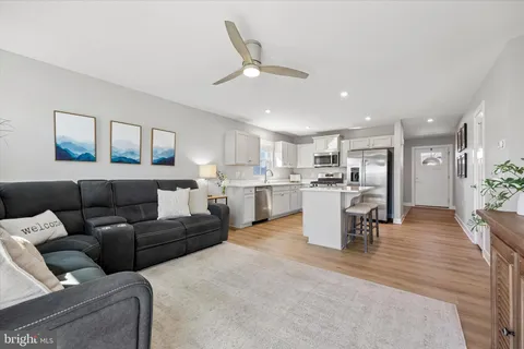 a living room with furniture and kitchen view