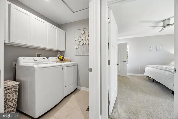 a utility room with closet dryer and washer