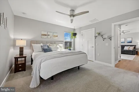 a spacious bedroom with a bed and a chandelier