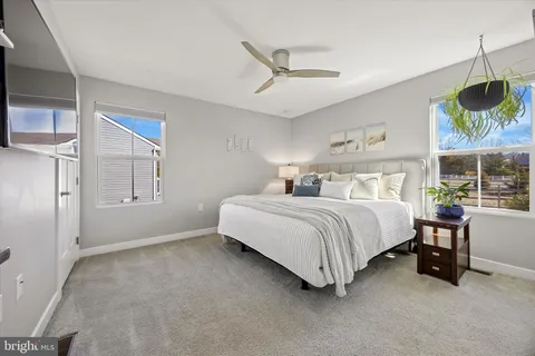 a bedroom with a bed dresser and a window