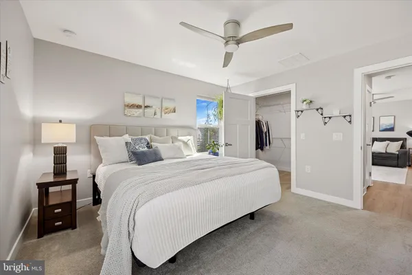 a spacious bedroom with a bed and a walk in closet