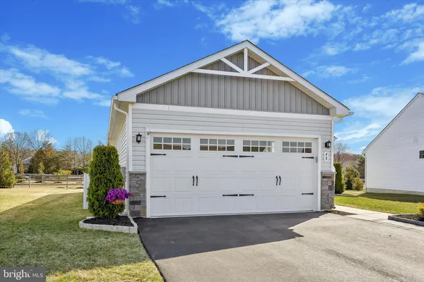 a very nice looking house with a big yard and large trees