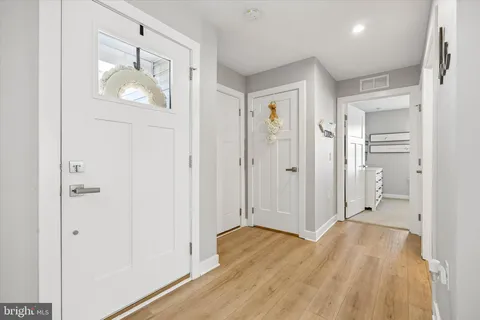 a view of empty room with wooden floor