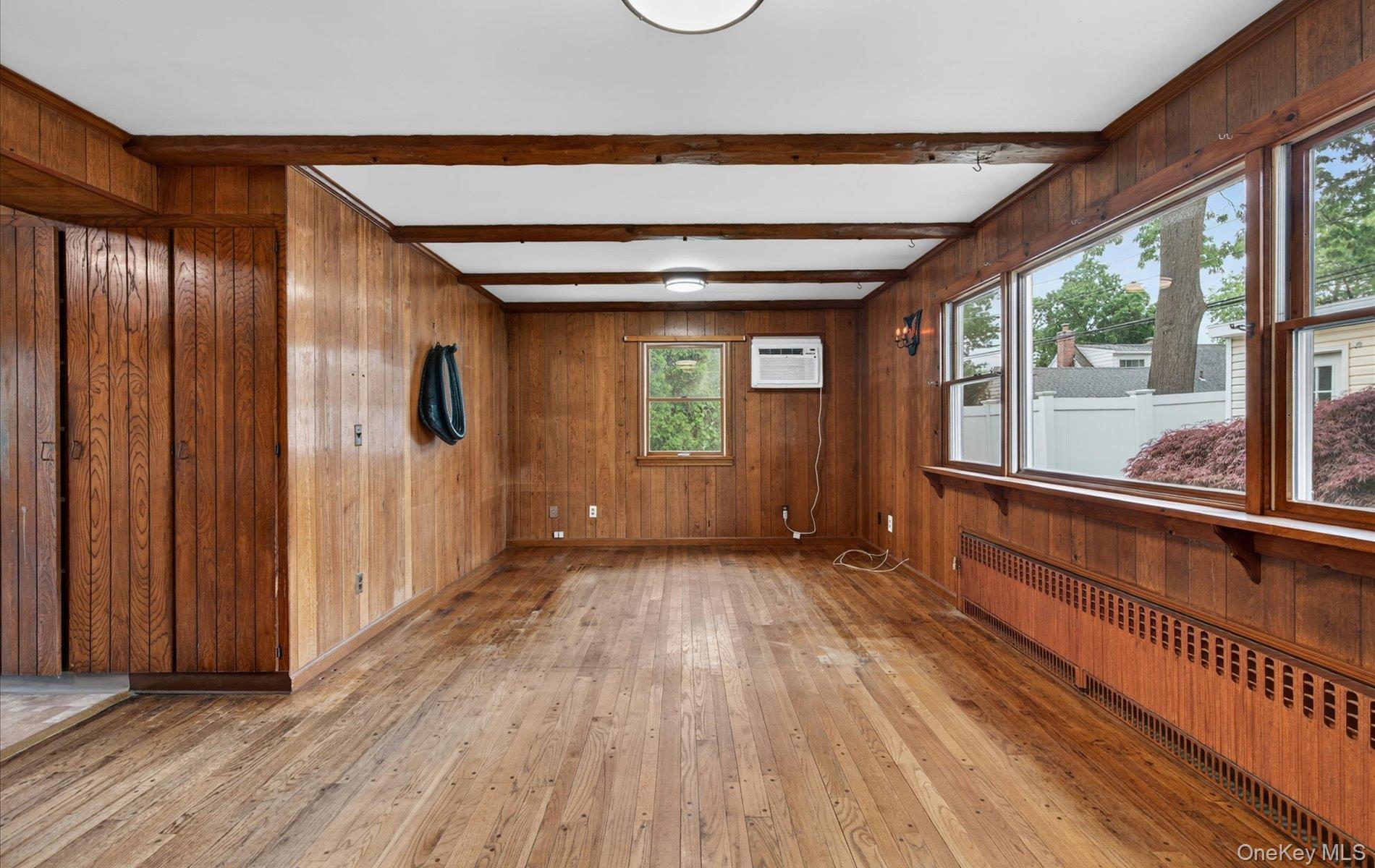 24 Purdue Road Glen Cove, NY 11542 - Photo 17 of 41 a view of hallway with a large window and wooden floor