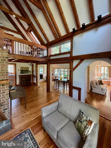 a dining room with furniture and wooden floor