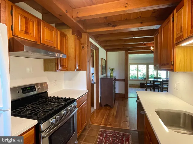 a living room with furniture a fireplace and a large window