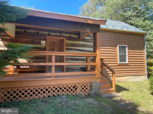 a view of outdoor space with green field and trees all around