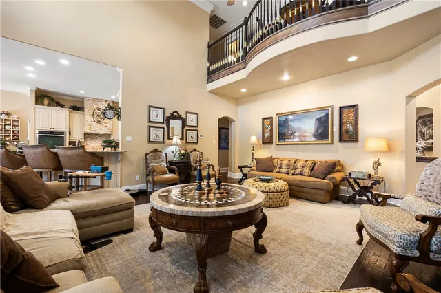 a living room with furniture and a view of kitchen