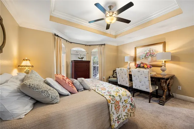 a bedroom with furniture and a large window