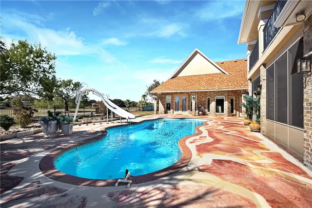 a view of a house with swimming pool and sitting area