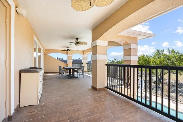 a view of a porch with a table and chairs and a barbeque