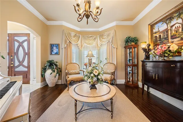 a living room with furniture and a chandelier