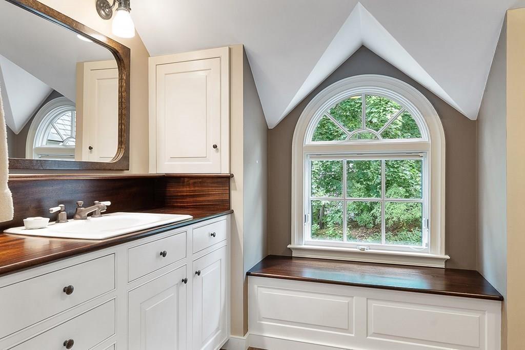 148 Monument Street Concord, MA 01742 - Photo 17 of 25 a bathroom with a sink a mirror and a window