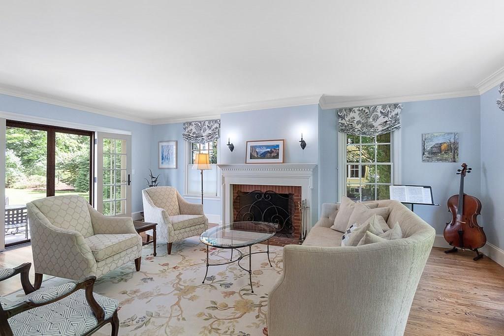 148 Monument Street Concord, MA 01742 - Photo 3 of 25 a living room with furniture and a fireplace