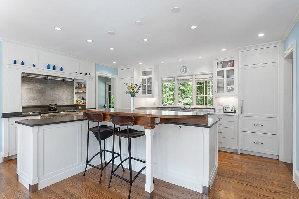 148 Monument Street Concord, MA 01742 - Photo 5 of 25 a kitchen with stainless steel appliances granite countertop a stove and a refrigerator