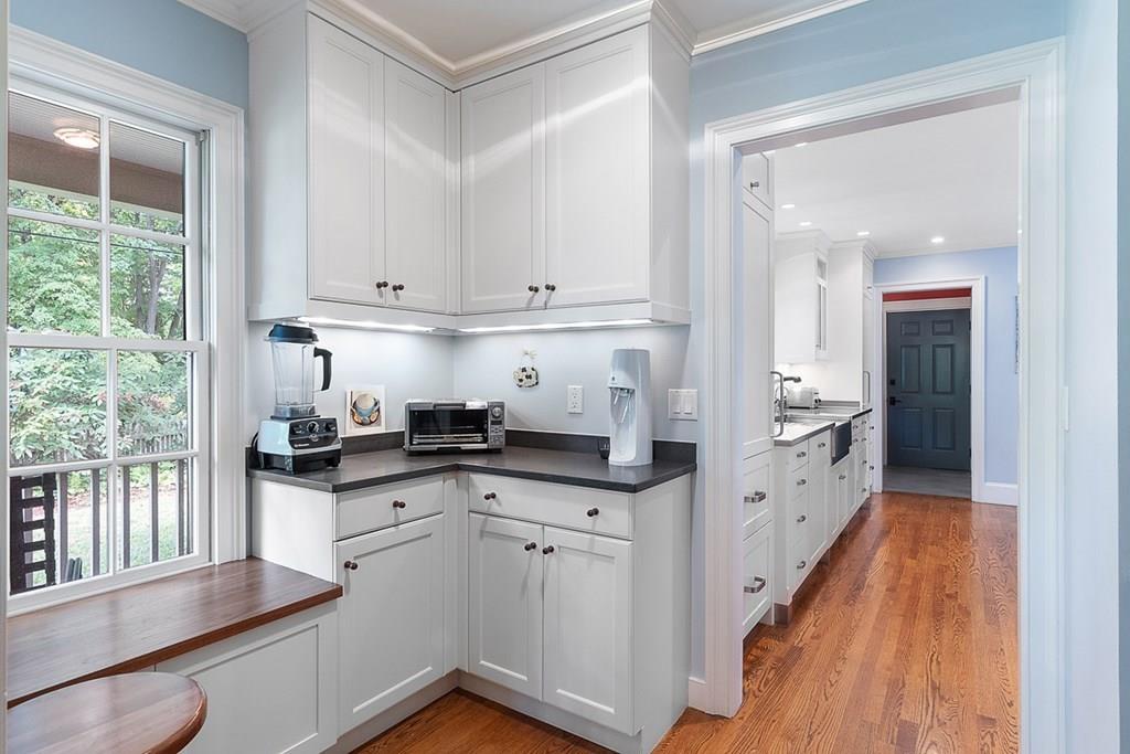 148 Monument Street Concord, MA 01742 - Photo 6 of 25 a kitchen with granite countertop a sink stove and cabinets