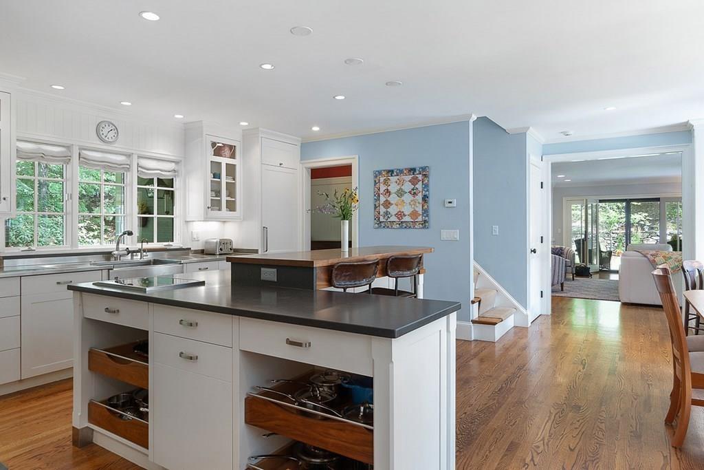 148 Monument Street Concord, MA 01742 - Photo 8 of 25 a kitchen with counter top space a sink cabinets and wooden floor