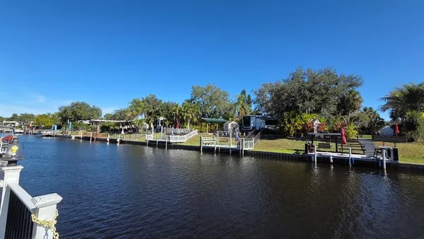 a view of a lake with boats and trees in the background