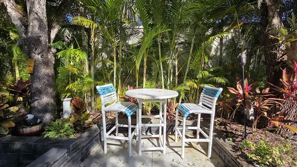 a view of a chairs and table in a patio