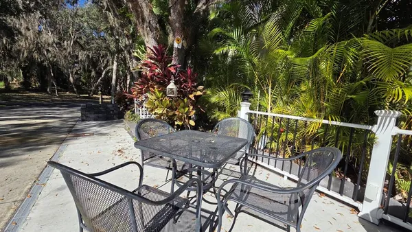 a view of a chairs and table in the patio