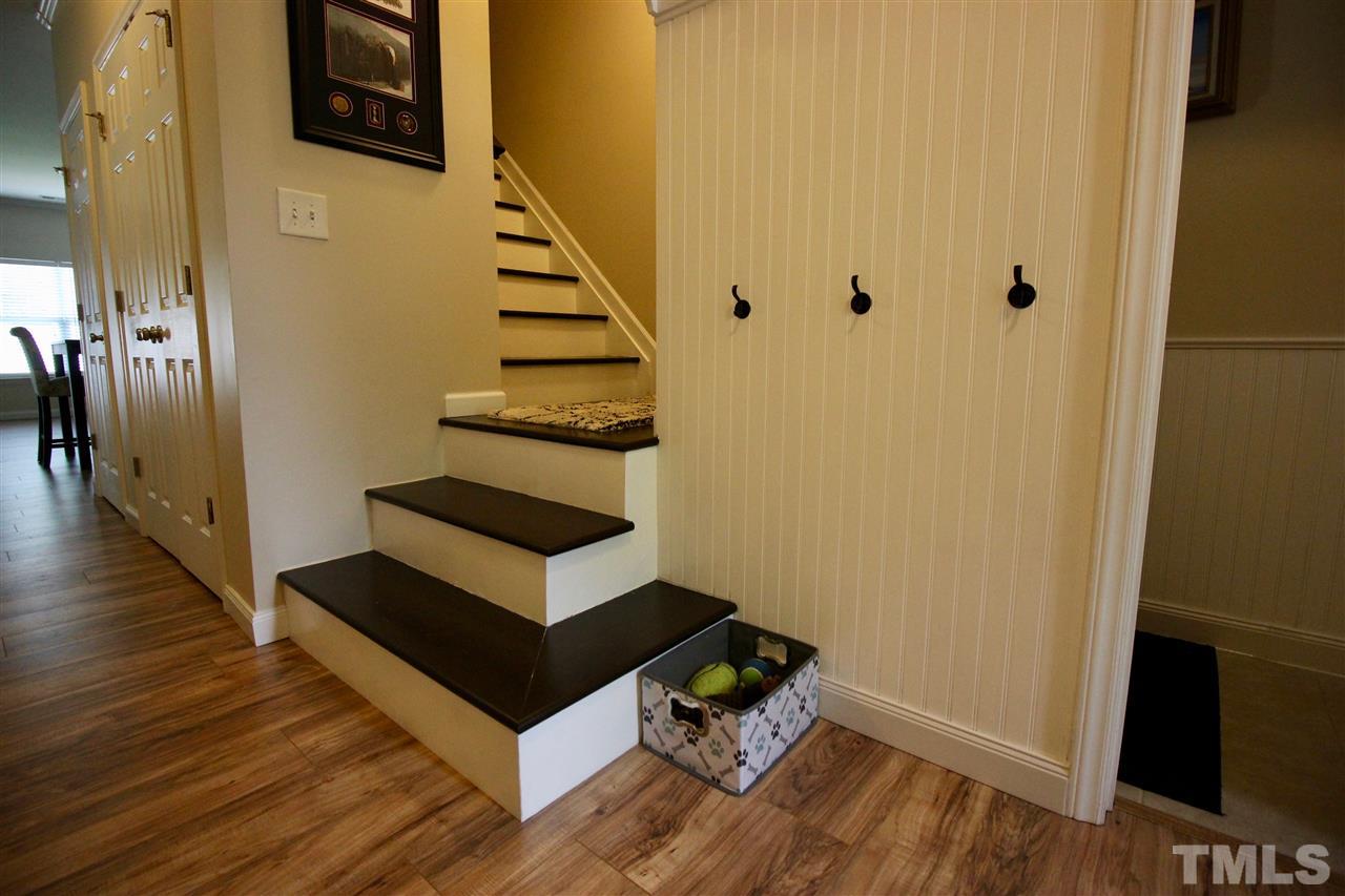 5059 Sandy Banks Road Raleigh, NC 27616 - Photo 2 of 25 New laminate flooring on entire first floor. Mud room wall with beadboard just inside the entrance. Carpet removed from stairs and the stairs are painted black.
