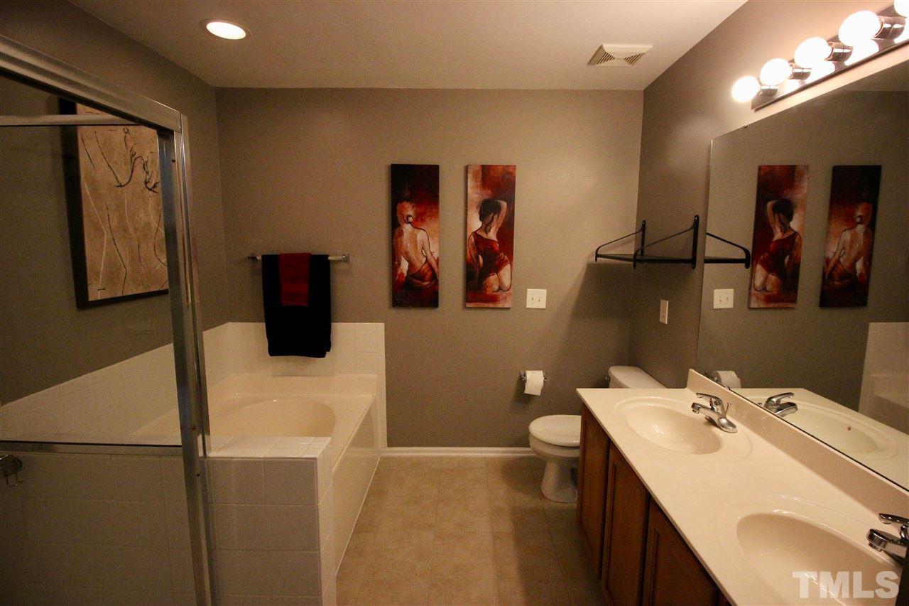 5059 Sandy Banks Road Raleigh, NC 27616 - Photo 6 of 25 Enjoy the spa like master bath with double vanities, a large soaking tub, and a large tiled shower.