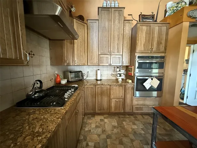 a view of a hallway with entryway wooden floor and front door