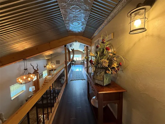 a view of gym equipment with wooden floor