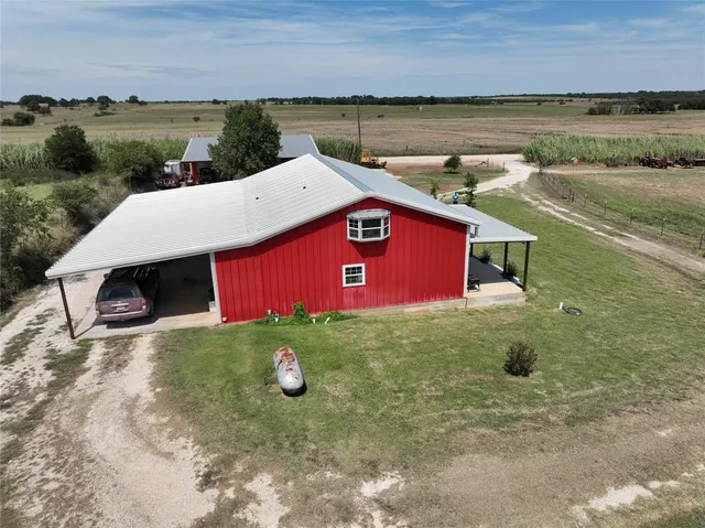 an aerial view of residential house with outdoor space and parking