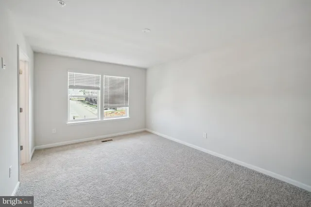 a view of an empty room and closet area