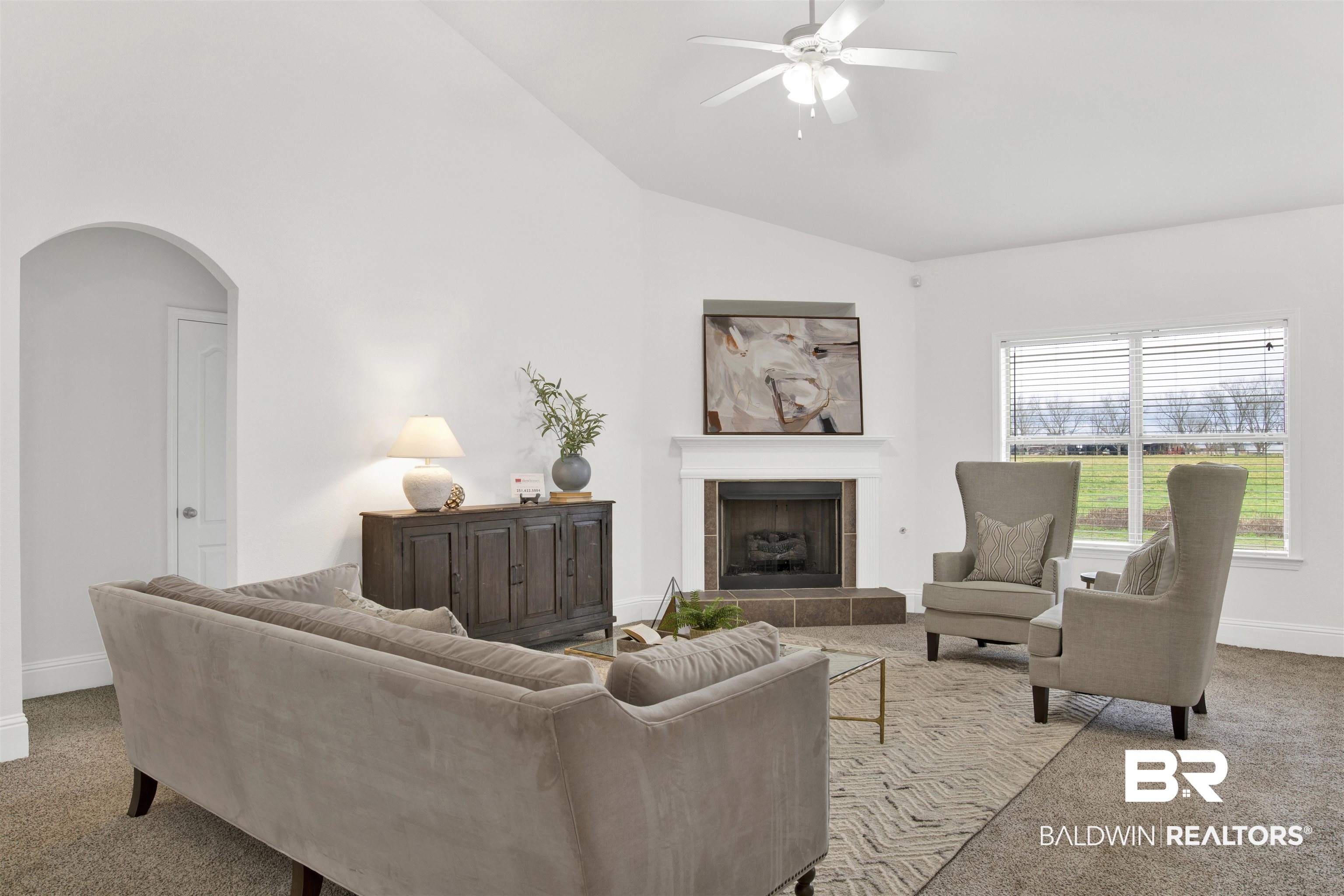 25350 Spindle Lane Daphne, AL 36526 - Photo 8 of 32 Carpeted living room featuring ceiling fan, high vaulted ceiling, and a fireplace