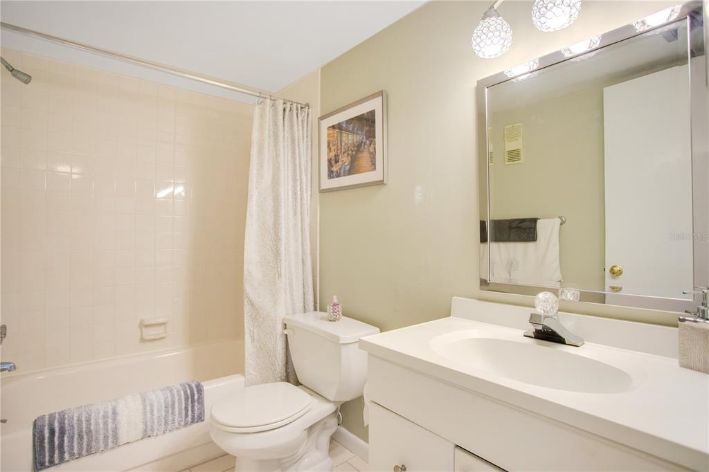 12200 Vonn Road, Unit 1209 Largo, FL 33774 - Photo 12 of 18 a bathroom with a sink a toilet and shower