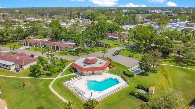 an aerial view of residential houses with outdoor space and swimming pool