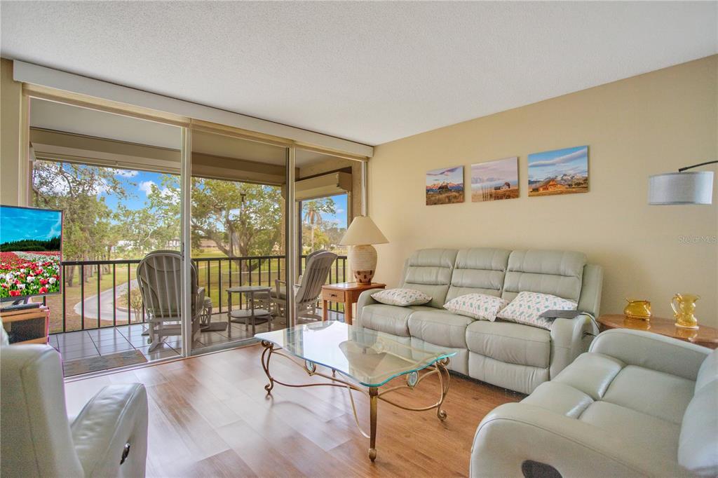 12200 Vonn Road, Unit 1209 Largo, FL 33774 - Photo 2 of 18 a living room with furniture and a large window