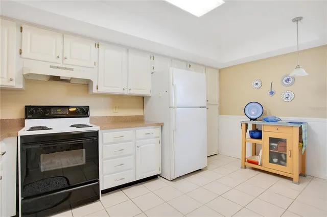 a kitchen with cabinets and a stove top oven