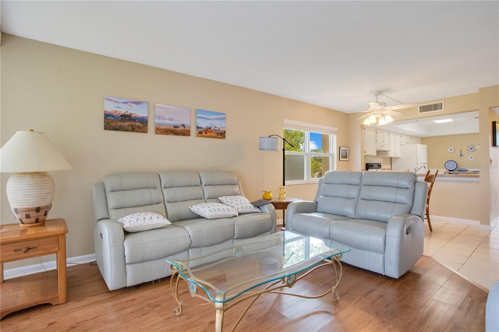 12200 Vonn Road, Unit 1209 Largo, FL 33774 - Photo 6 of 18 a living room with furniture and wooden floor