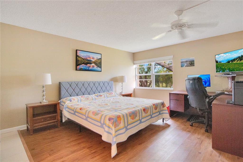 12200 Vonn Road, Unit 1209 Largo, FL 33774 - Photo 8 of 18 a bedroom with a bed wooden floor and window
