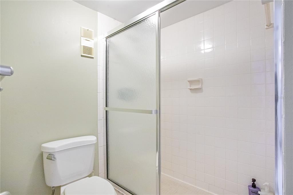 12200 Vonn Road, Unit 1209 Largo, FL 33774 - Photo 10 of 18 a white toilet sitting next to a shower